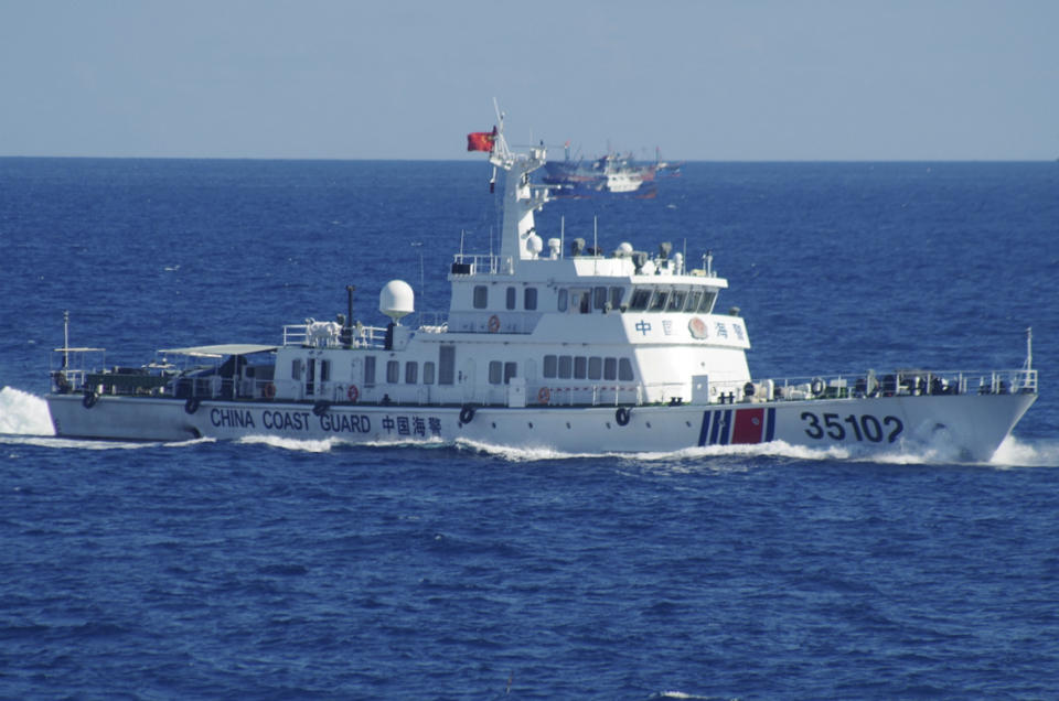 FILE - In this photo released by the 11th Regional Coast Guard Headquarters of Japan, a Chinese coast guard vessel sails near disputed East China Sea islands on Aug. 6, 2016. Japan has been building up its defenses to counter strategic threats, but its arms industry is struggling both on the home front and overseas. (11th Regional Coast Guard Headquarters via AP, File)