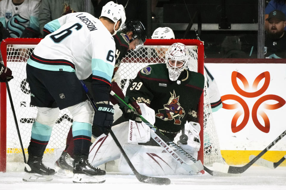 Arizona Coyotes goaltender Connor Ingram (39) makes a save on a shot by Seattle Kraken defenseman Adam Larsson (6) during the first period of an NHL hockey game Tuesday, Nov. 7, 2023, in Tempe, Ariz. (AP Photo/Ross D. Franklin)