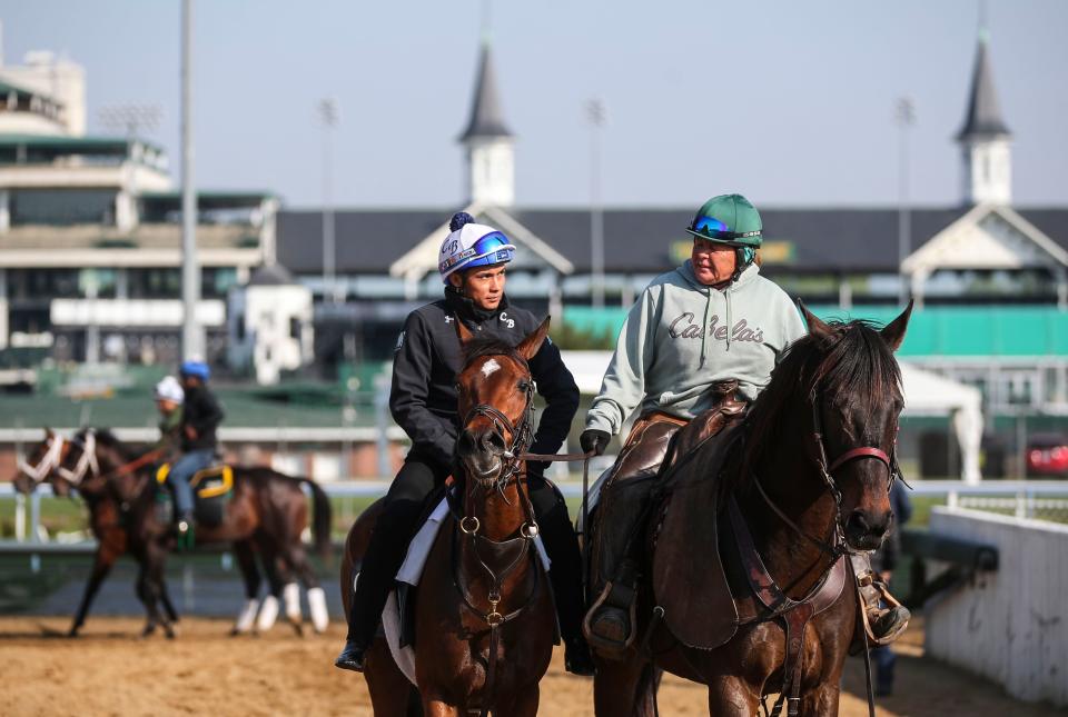 Pony rider Monnie Goetz escorts a horse and exercise rider from the track after a workout at the track April 25, 2023 at Churchill Downs in Louisville, Ky. 
