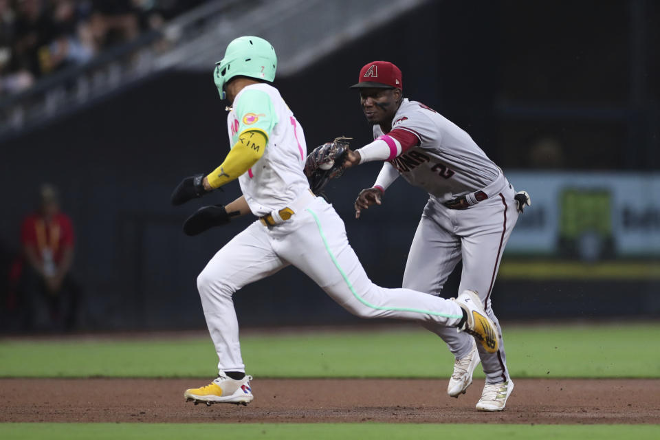 Arizona Diamondbacks shortstop Geraldo Perdomo, right, tags out San Diego Padres' Ha-Seong Kim, who was trying to advance to third base on a ball hit by Austin Nola in the third inning of a baseball game Friday, July 15, 2022, in San Diego. (AP Photo/Derrick Tuskan)
