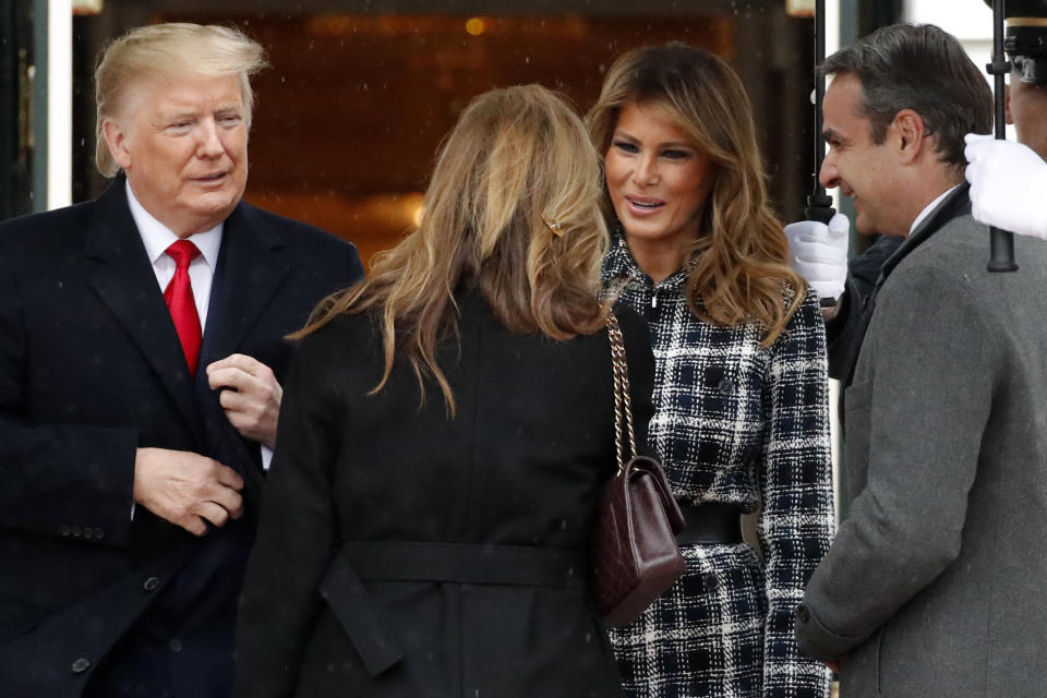 President Donald Trump, accompanied by first lady Melania Trump, welcome Greek Prime Minister Kyriakos Mitsotakis and his wife Mareva Grabowski-Mitsotakis as they arrive on the South Lawn of the White House, Tuesday, Jan. 7, 2020, in Washington. (AP Photo/Alex Brandon)