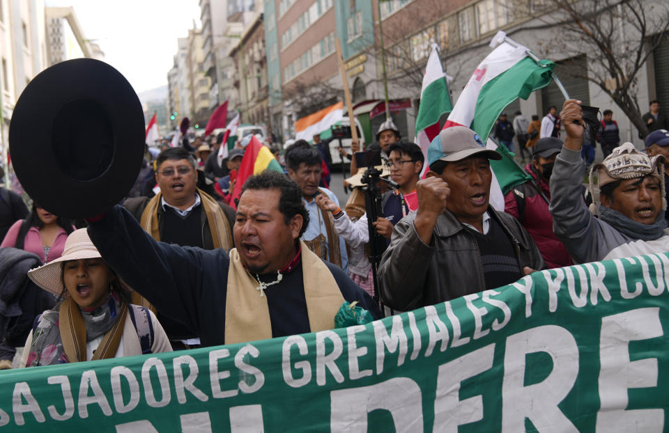 FILE - Merchants shout slogans during an anti-government march against the banks' lack of U.S. dollars, in La Paz, Bolivia, June 17, 2024. With prices surging, dollars scarce and lines snaking away from fuel-strapped gas stations, protests in Bolivia have intensified over the economy's precipitous decline. (AP Photo/Juan Karita, File)