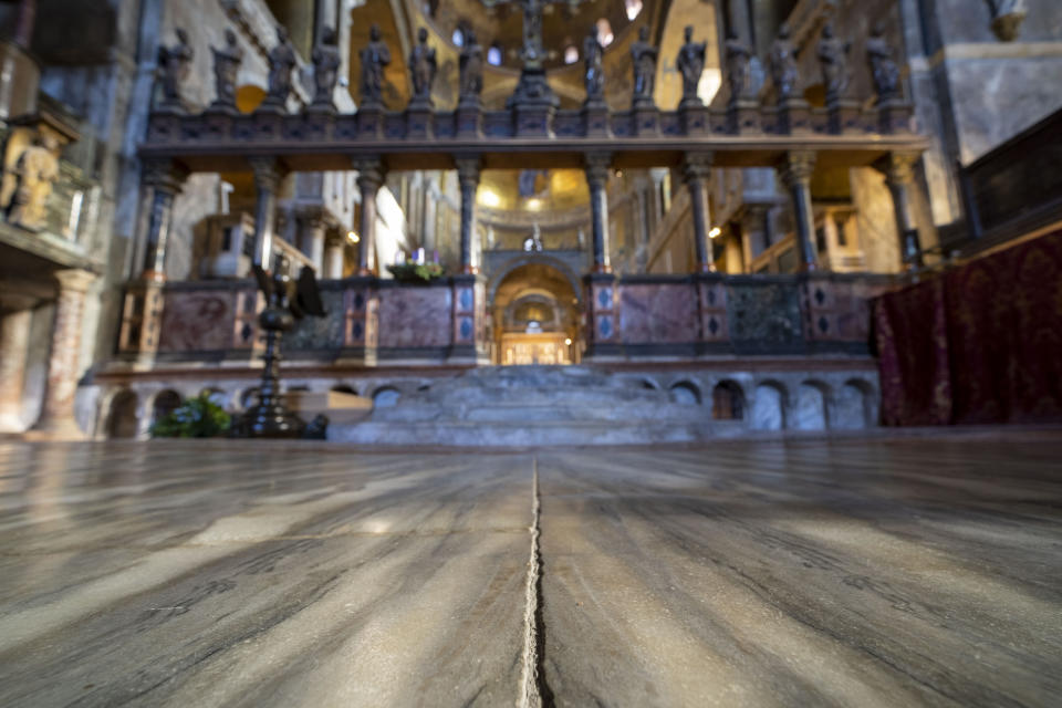 Signs of erosion are visible inside St. Mark's Basilica in Venice, northern Italy, Wednesday, Dec. 7, 2022. Glass barriers that prevent seawater from flooding the 900-year-old Venice's iconic Basilica during high tides have been recently installed. St. Mark's Square is the lowest-laying city area and frequently ends up underwater during extreme weather. (AP Photo/Domenico Stinellis)