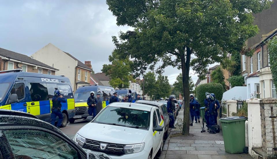 Territorial Support Group officers and vans at the scene in Eglinton Road (Rosie Shead/PA Wire)