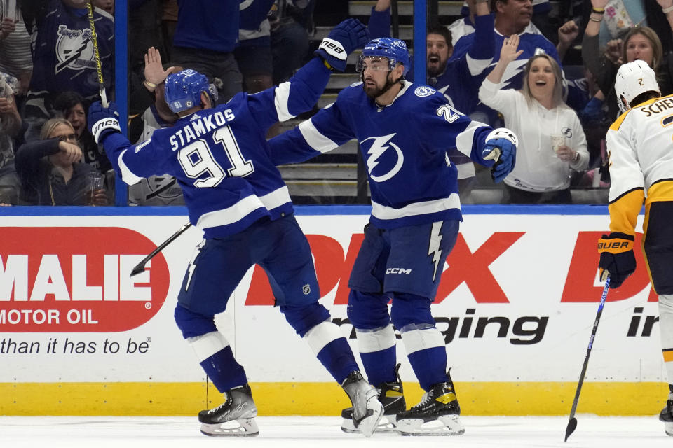 Tampa Bay Lightning left wing Nicholas Paul (20) celebrates his goal against the Nashville Predators with center Steven Stamkos (91) during the third period of an NHL hockey game Tuesday, Oct. 10, 2023, in Tampa, Fla. (AP Photo/Chris O'Meara)