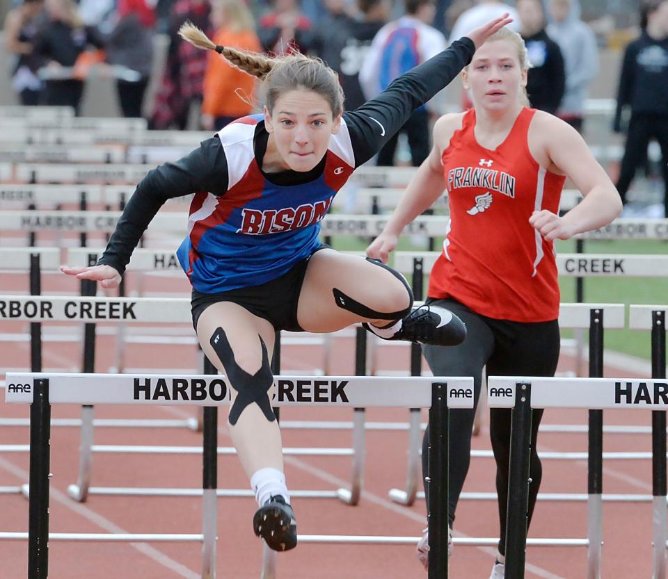 Fort LeBoeuf High School senior Mackenzie Huston, center, wins the 100-meter hurdles during the Harbor Creek track and field invitational at Paul J. Weitz Stadium in Harborcreek Township on April 23, 2022. Franklin Area senior Abby Williams is at right.