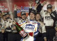 FILE - In this May 17, 2003, file photo, Jimmie Johnson, center, celebrates with his crew in victory lane after winning The Winston, NASCAR's all-star race, in Concord, N.C. Seven-time NASCAR champion Jimmie Johnson says 2020 will be his final season of full-time racing. The winningest driver of his era will have a 19th season in the No. 48 Chevrolet and once again chase a record eighth championship. Johnson made the announcement in a video posted on social media, Wednesday, Nov. 20, 2019.(AP Photo/Chuck Burton, File)
