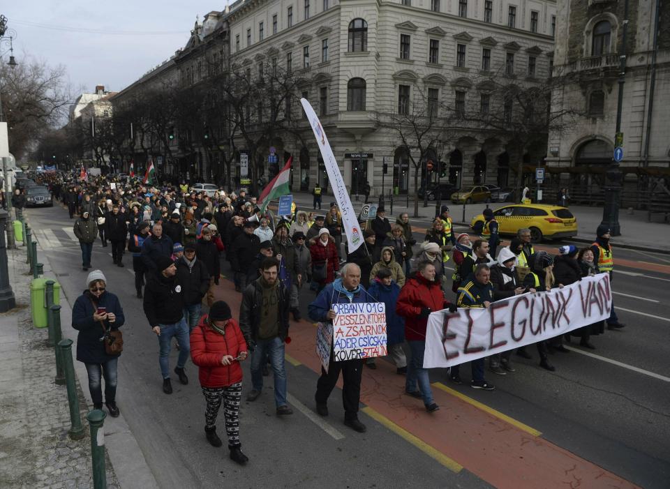 Demonstrators carry a banner reading 'We are fed up' as they protest against the recent amendments to the labour code, dubbed 'slave law' by opposition forces, in downtown Budapest, Hungary, Saturday, Jan. 19, 2019. (Zoltan Balogh/MTI via AP)