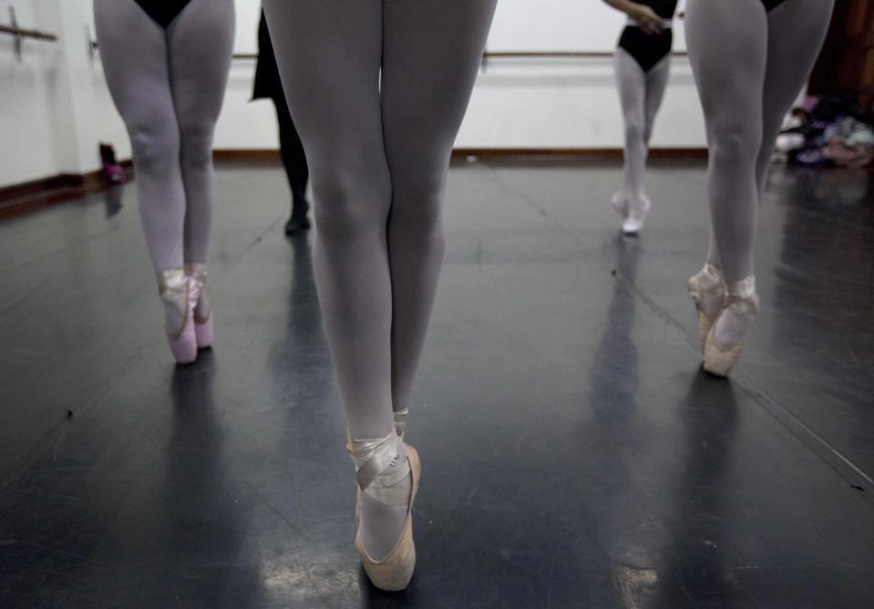 In this Aug. 28, 2012 photo, ballet dancers practice for a competition between ballet schools at the National Superior Ballet School in Lima, Peru. Nearly 100 girls and boys from Colombia, Venezuela, Chile, France and Peru are submitting themselves to a week-long competition hoping to win medals from Peru's national ballet school _ and perhaps a grant to study in Miami. (AP Photo/Martin Mejia)