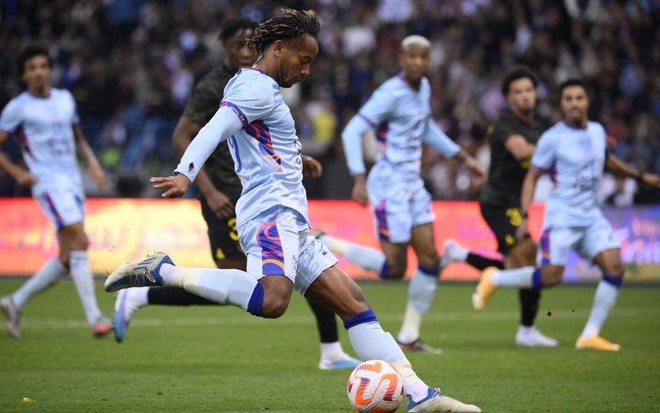 Riyadh All-Star's Peruvian midfielder Andre Carrillo (L) shoots during the Riyadh Season Cup football match - AFP