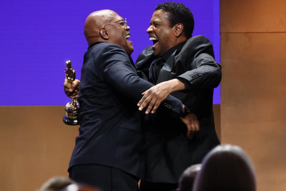 Samuel L. Jackson and Denzel Washington embrace onstage during the 2022 Governors Awards at The Ray Dolby Ballroom at Hollywood & Highland Center on March 25, 2022, in Hollywood, California. Jackson was awarded an honorary Oscar.