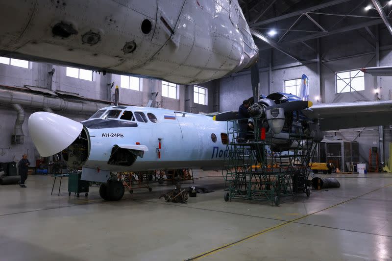 A Polar Airlines' Antonov An-24 passenger aircraft is serviced at an airport in Yakutsk