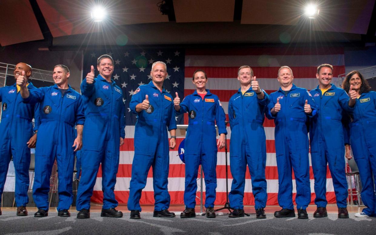 (L-R) Victor Glover, Mike Hopkins, Bob Behnken, Doug Hurley, Nicole Aunapu Mann, Chris Ferguson, Eric Boe, Josh Cassada, and Suni Williamson at NASA's Johnson Space Center in Houston, Texas  - AFP