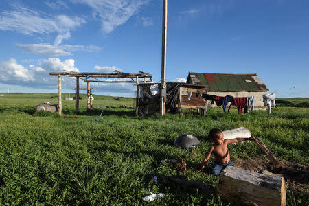 Cody Lookinghorse plays in the backyard of Beatrice Lookinghorse's home on the Cheyenne River Reservation in Green Grass, South Dakota, U.S., May 29, 2018. REUTERS/Stephanie Keith