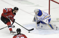 New Jersey Devils center Nico Hischier (13) skates in on Buffalo Sabres goaltender Linus Ullmark (35) during the second period of an NHL hockey game Tuesday, Feb. 23, 2021, in Newark, N.J. (AP Photo/Bill Kostroun)