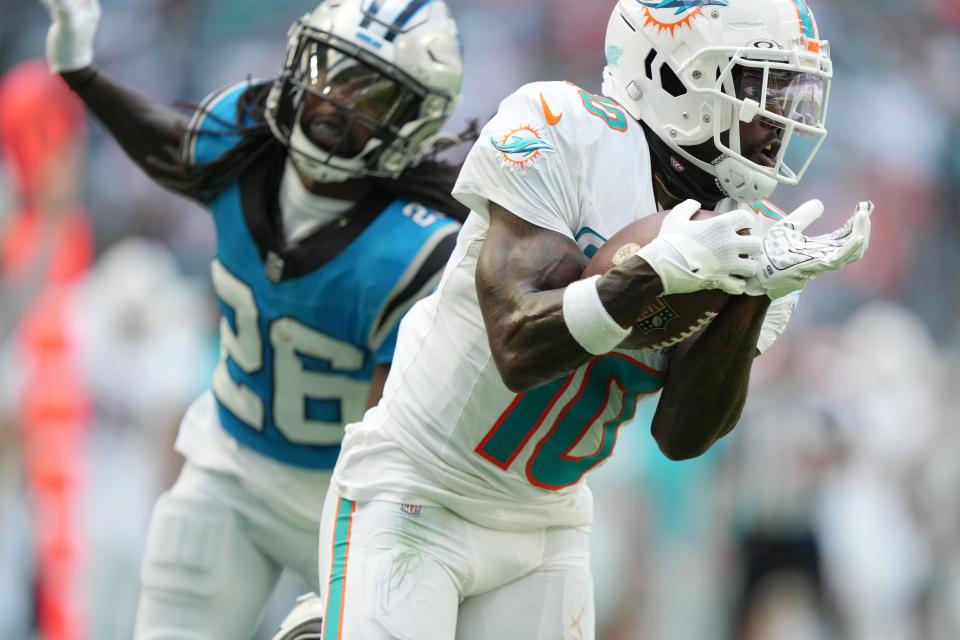 Miami Dolphins wide receiver <a class="link " href="https://sports.yahoo.com/nfl/players/29399" data-i13n="sec:content-canvas;subsec:anchor_text;elm:context_link" data-ylk="slk:Tyreek Hill;sec:content-canvas;subsec:anchor_text;elm:context_link;itc:0">Tyreek Hill</a> (10) catches a pass for a touchdown as <a class="link " href="https://sports.yahoo.com/nfl/teams/carolina/" data-i13n="sec:content-canvas;subsec:anchor_text;elm:context_link" data-ylk="slk:Carolina Panthers;sec:content-canvas;subsec:anchor_text;elm:context_link;itc:0">Carolina Panthers</a> cornerback <a class="link " href="https://sports.yahoo.com/nfl/players/31025" data-i13n="sec:content-canvas;subsec:anchor_text;elm:context_link" data-ylk="slk:Donte Jackson;sec:content-canvas;subsec:anchor_text;elm:context_link;itc:0">Donte Jackson</a> (26) follows on the play during the first half of an NFL game at Hard Rock Stadium in Miami Gardens, Oct. 15, 2023.