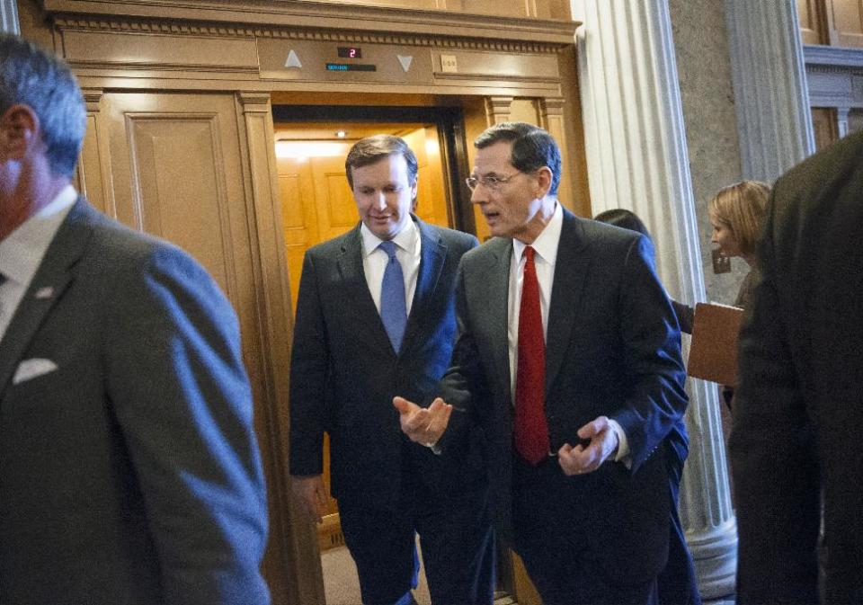 Senate Foreign Relations Committee members Sen. Chris Murphy, D-Conn., left, and Sen. John Barrasso, R-Wyo., right, arrive on Capitol Hill in Washington, Thursday, March 27, 2014, for a Senate vote on the Ukraine Aid Bill. The Senate approved the legislation by voice vote Thursday at the same time the House was passing a different version on a 399-19 vote.(AP Photo/J. Scott Applewhite)
