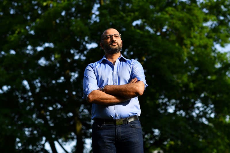 Human rights lawyer Mazen Masri poses for a portrait outside his house in north London