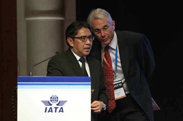 Chief Executive and Director General of the International Air Transport Association (IATA) Tony Tyler, right, talks to Malaysia's Department of Civil Aviation Director General Azharuddin Abdul Rahman after Azharuddin stopped his speech halfway and requested journalists to leave the conference room during the IATA Ops Conference in Kuala Lumpur, Malaysia, Tuesday, April 1, 2014. (AP Photo/Lai Seng Sin)