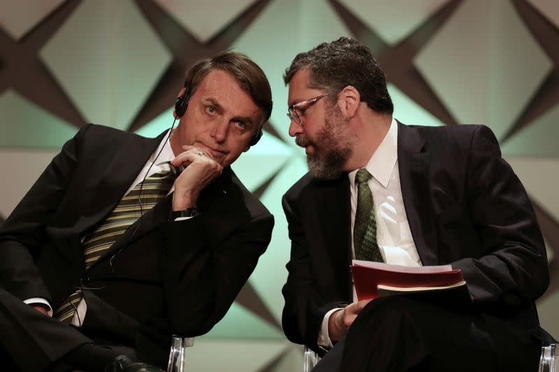 FILE PHOTO: Brazil's President Jair Bolsonaro talks to Minister of Foreign Affairs Ernesto Araujo during the Brazil Investment Forum in Sao Paulo