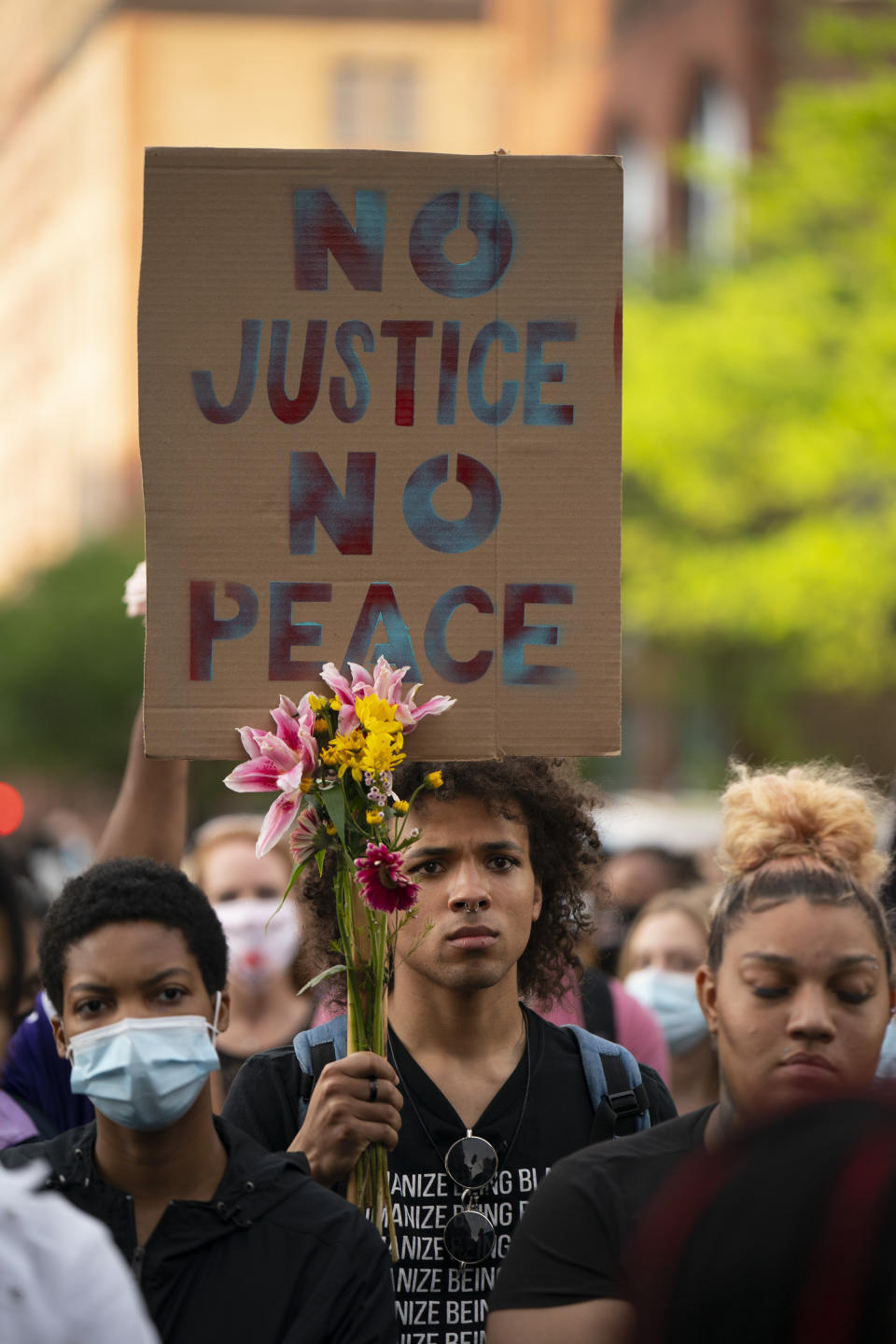 People listen to a speaker during a rally and march in downtown Minneapolis, Sunday, May 23, 2021. Members of George Floyd’s family, and others who lost loved ones to police encounters, joined activists and citizens in Minneapolis for a march that was one of several events planned nationwide to mark the one-year anniversary of Floyd’s death. (Jeff Wheeler/Star Tribune via AP)