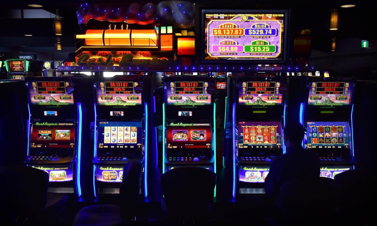 <span>A man sits at a poker machine in the gaming room at the Vikings Club in Canberra, Australia. Despite having less than half a percent of the world's population, Australia is home to a fifth of the world's slot machines.</span><span>Photograph: Bloomberg/Getty Images</span>