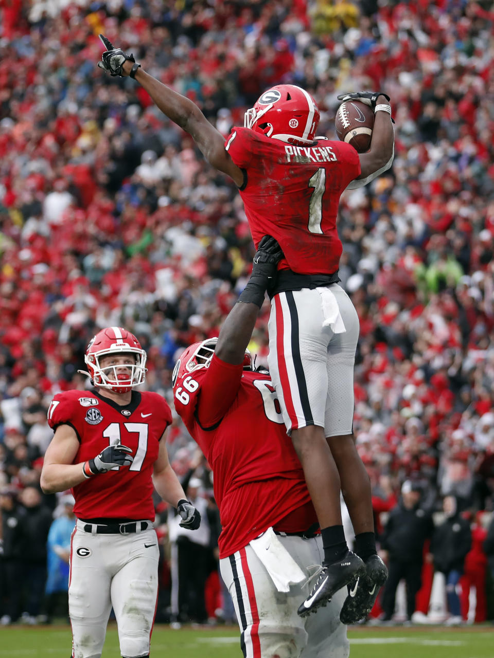 Georgia wide receiver George Pickens (1) celebrates with offensive lineman Solomon Kindley (66) after catching a touchdown on a pass from quarterback Jake Fromm (17) during the first half of an NCAA college football game against Texas A&M, Saturday, Nov. 23, 2019, in Athens, Ga. (AP Photo/John Bazemore)