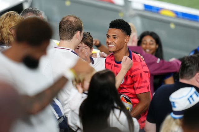 Watkins (centre) take photos with fans after the match 