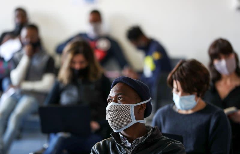 FILE PHOTO: Vaccine trials' volunteers wait for their names to be called before testing for the coronavirus disease (COVID-19), and taking part of the country's human clinical trial for potential vaccines at the Wits RHI Shandukani Research Centre in Johan