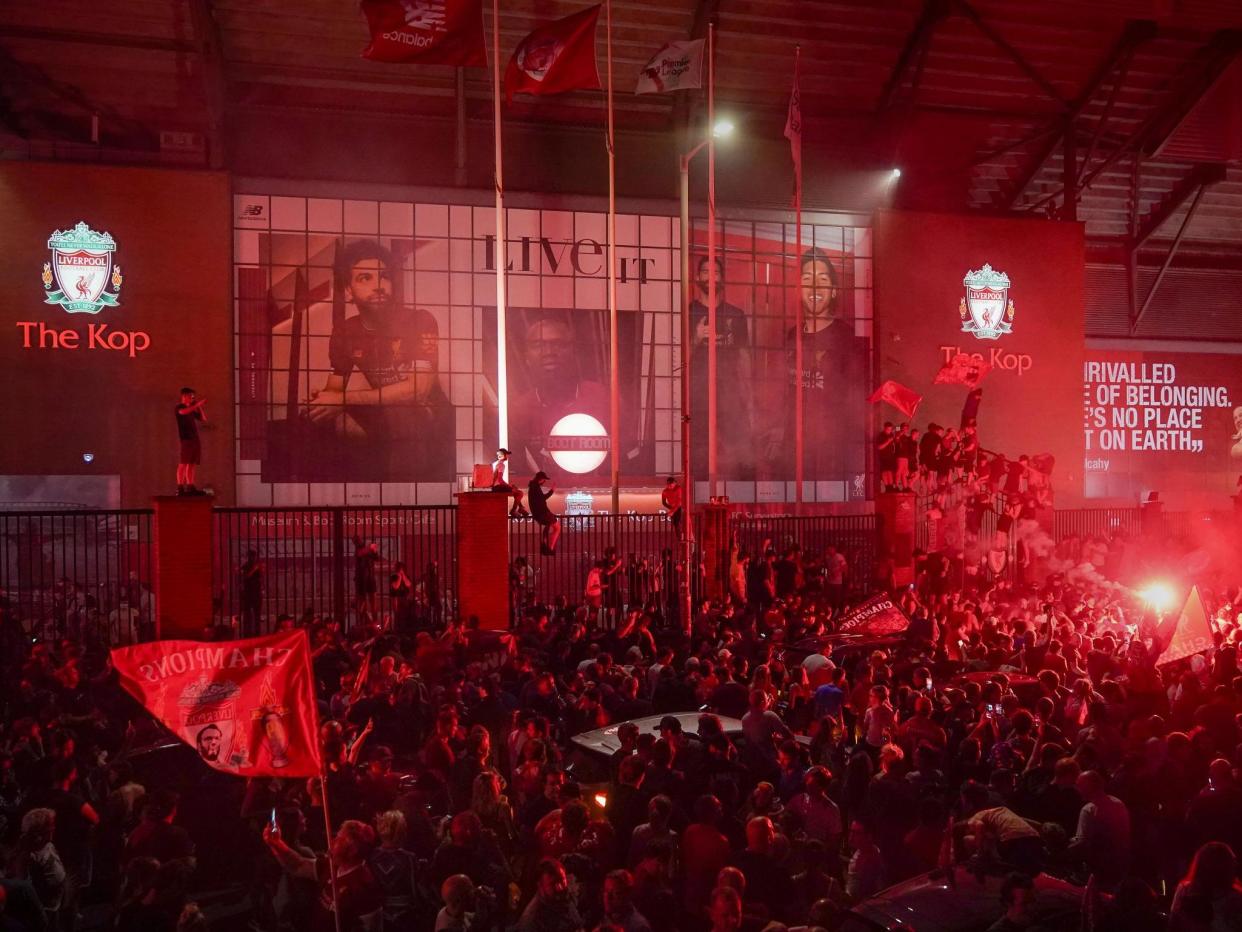 Liverpool fans celebrate winning the Premier League title: Getty