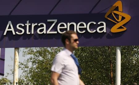 A man walks past a sign at an AstraZeneca site in Macclesfield, central England May 19, 2014. REUTERS/Phil Noble