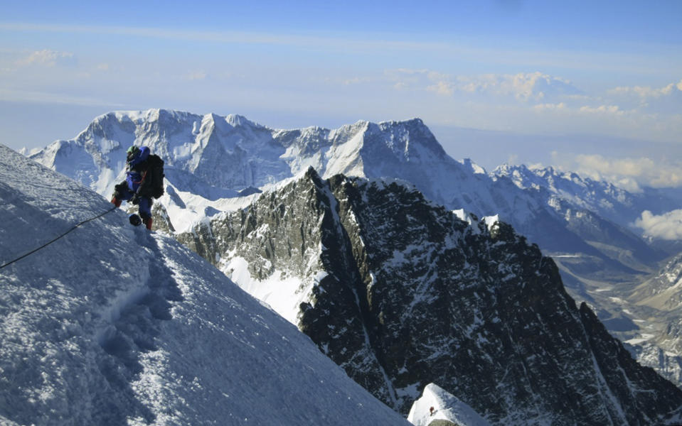 In this May 18, 2013 photo released by Alpenglow Expeditions, a climber pauses on the way to the summit of Mount Everest, in the Khumbu region of the Nepal Himalayas. Nepal will slash the climbing fees for Mount Everest to attract more mountaineers to the world's highest peak, even as concerns grow about the environmental effects of thousands of climbers who already crowd the mountain during the high season. Madhusudan Burlakoti, head of Nepal's Department of Mountains, said Friday, Feb. 14, 2014 that beginning next year, it will cost $11,000 per climber to climb Everest. (AP Photo/Alpenglow Expeditions, Adrian Ballinger) MANDATORY CREDIT, EDITORIAL USE ONLY