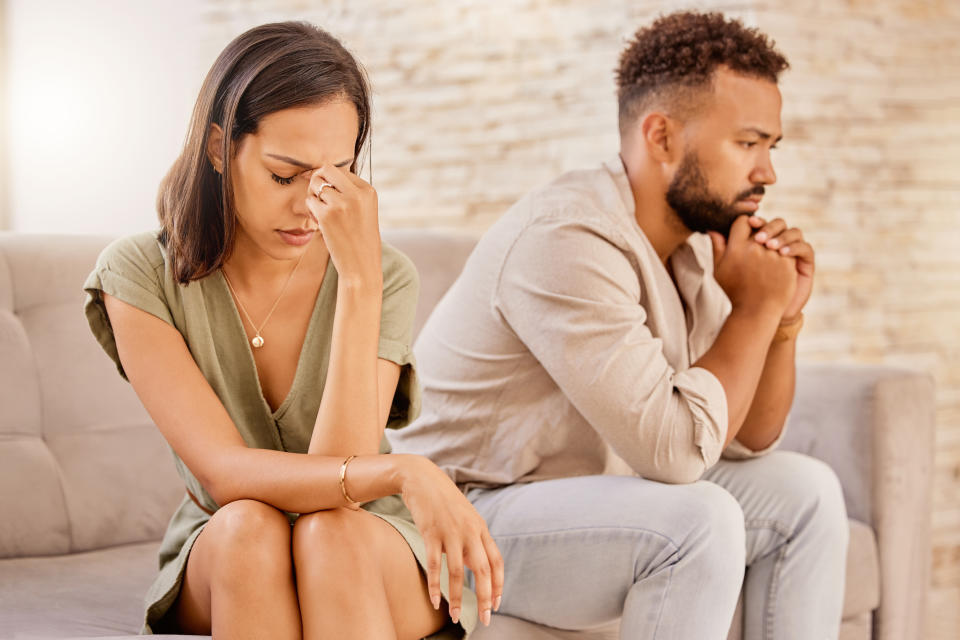 Fight, divorce and depression with partner on sofa for conflict, therapy and mental health or marriage counseling. Sad, anxiety and stress with man and woman in living room for fail, crisis and angry
