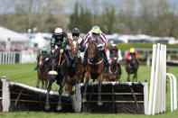 Strong Leader, ridden by jockey S. Bowen, left, clears an obstacle on their way to win the JRL Group Liverpool Hurdle race on the third day of the Grand National Horse Racing meeting at Aintree racecourse, near Liverpool, England, Saturday, April 13, 2024. Organizers of Britain's biggest horse race have taken action to improve safety and avoid a repeat of the chaos sparked by animal-rights activists before last year's edition.(AP Photo/Dave Shopland)