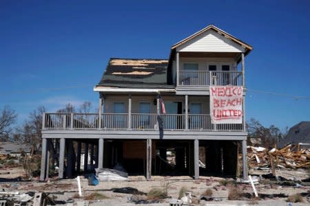 A sign is pictured on a damaged building in Mexico Beach, October 12, 2018. REUTERS/Carlo Allegri