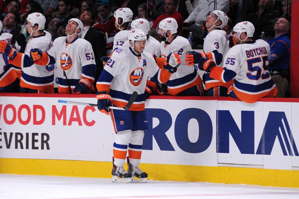 MONTREAL, QC - JANUARY 17: Kyle Okposo #21 of the New York Islanders celebrates his second period goal with teammates during the NHL game against the Montreal Canadiens at the Bell Centre on January 17, 2015 in Montreal, Quebec, Canada. (Photo by Richard Wolowicz/Getty Images)