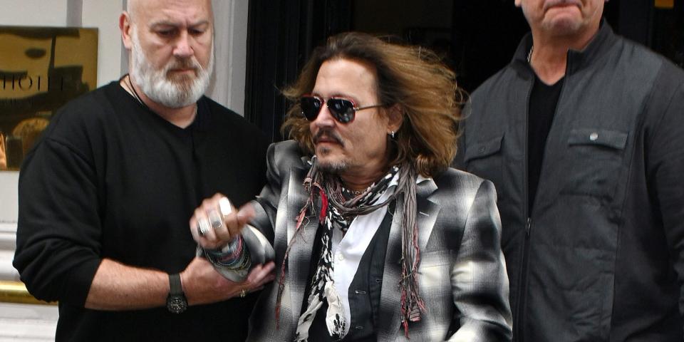 Johnny Depp leaving a hotel with a minder behind him on June 6, 2022 in Birmingham, England