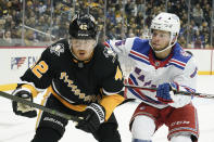 New York Rangers' Zac Jones (6) checks Pittsburgh Penguins' Kasperi Kapanen (42) during the second period of an NHL hockey game, Saturday, Feb. 26, 2022, in Pittsburgh. (AP Photo/Keith Srakocic)