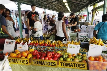 People shop at a farmer's market in the Capitol Hill neighborhood, where many government workers as well as members of Congress live while in session, in Washington October 5, 2013. REUTERS/Jonathan Ernst