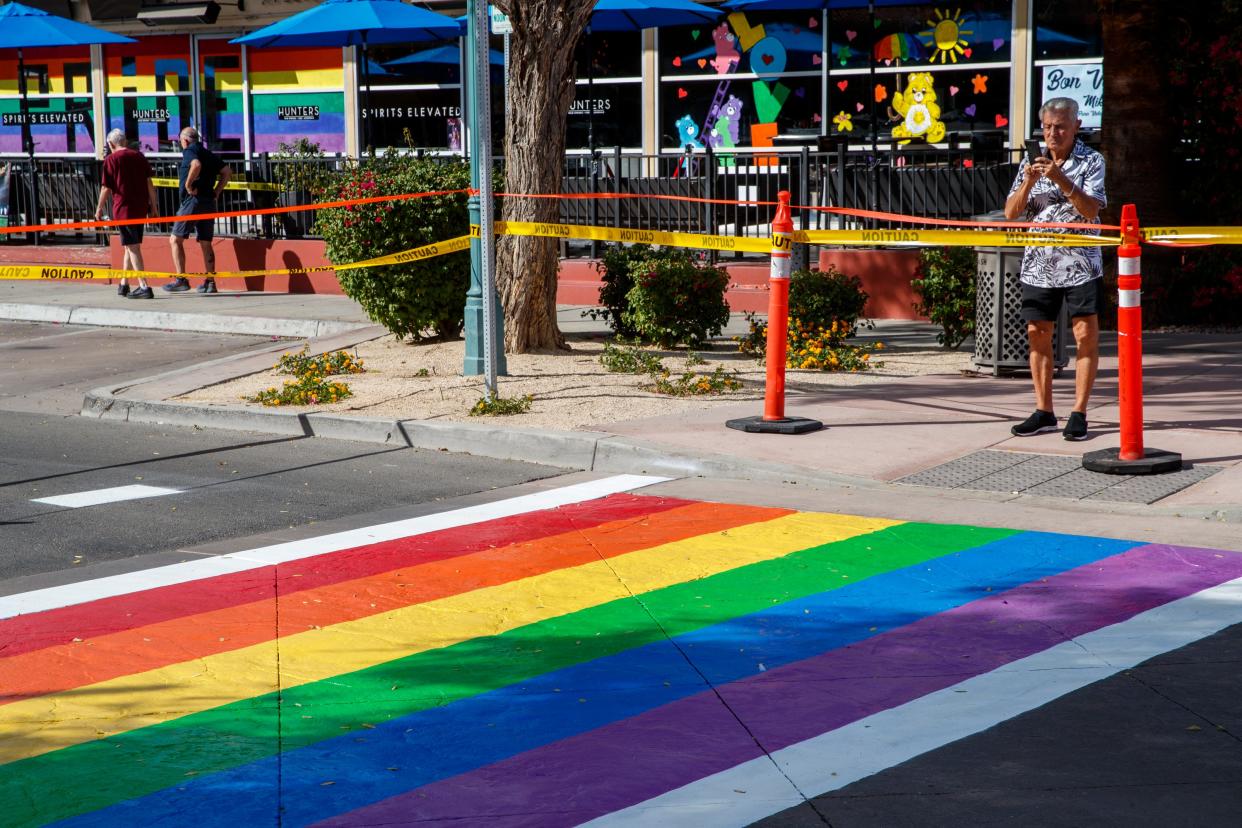 Tom Maccarone of Palm Springs takes a photograph of the crosswalk on Arenas Road at Calle Encilia in Palm Springs on Oct. 18, 2021. (Photo: Taya Gray, The Desert Sun)