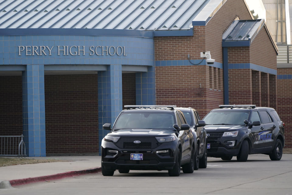 Police vehicles sit parked in front of Perry High School following a shooting Thursday at the school, Friday, Jan. 5, 2024, in Perry, Iowa. (AP Photo/Charlie Neibergall)