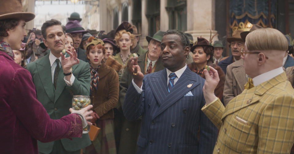 This image released by Warner Bros. Pictures shows, foreground from left, Timothee Chalamet, Mathew Baynton, Paterson Joseph and Matt Lucas in a scene from "Wonka." (Warner Bros. Pictures via AP)