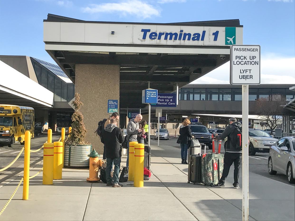 Salt Lake City, UT, 2/4/2019: Passengers are waiting at the Uber and Lyft designated pick up stop at SLC's Terminal 1.