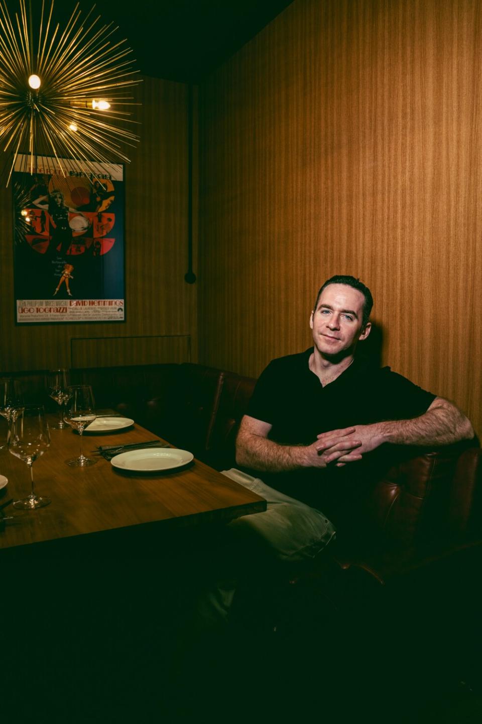 A man sits at a table at a restaurant