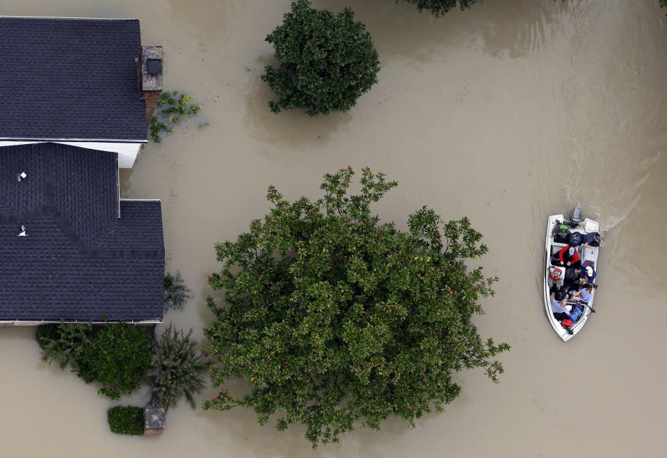 <p>Residents evacuate their homes near the Addicks Reservoir as floodwaters from Tropical Storm Harvey rise Tuesday, Aug. 29, 2017, in Houston. (Photo: David J. Phillip/AP) </p>