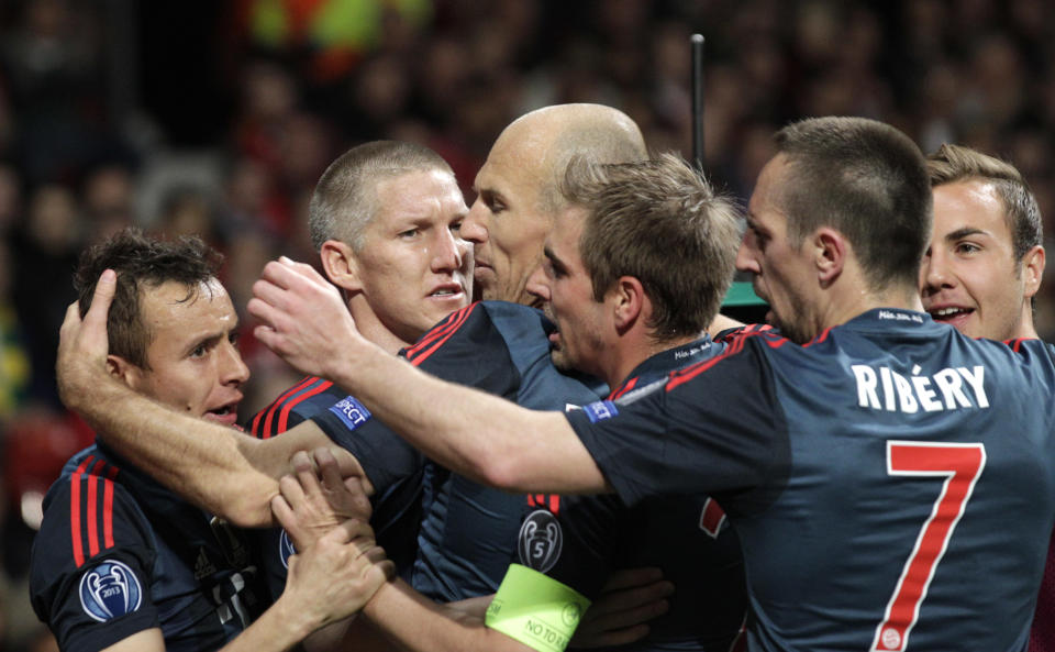 Bayern's Bastian Schweinsteiger, second left, celebrates with his teammates after scoring their side's first goal during the Champions League quarterfinal first leg soccer match between Manchester United and Bayern Munich at Old Trafford Stadium, Manchester, England, Tuesday, April 1, 2014.(AP Photo/Jon Super)