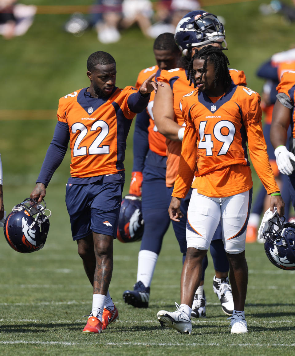 Denver Broncos strong safety Kareem Jackson, left, chats with cornerback Mac McCain III after NFL football practice at the team's headquarters, Thursday, Aug. 19, 2021, in Englewood, Colo. (AP Photo/David Zalubowski)