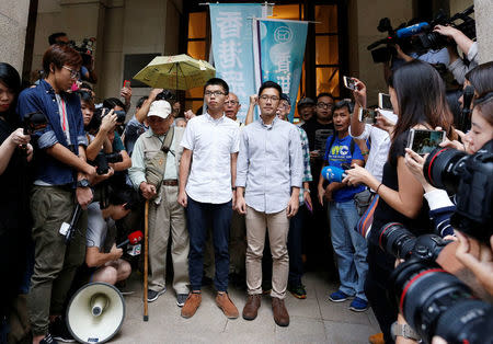 Pro-democracy activists Joshua Wong (L) and Nathan Law walk out of the Court of Final Appeal after being granted bail in Hong Kong, China, October 24, 2017. REUTERS/Bobby Yip