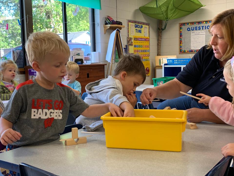 Preschool teacher Kathy Dahm helps (from left) Ryder, Rory and Charlotte pick out blocks during the activity session following afternoon naptime at KinderCare's Pine Street facility in Waukesha. KinderCare is among the most prevalent daycare centers in Waukesha and Milwaukee counties, with 23 locations.