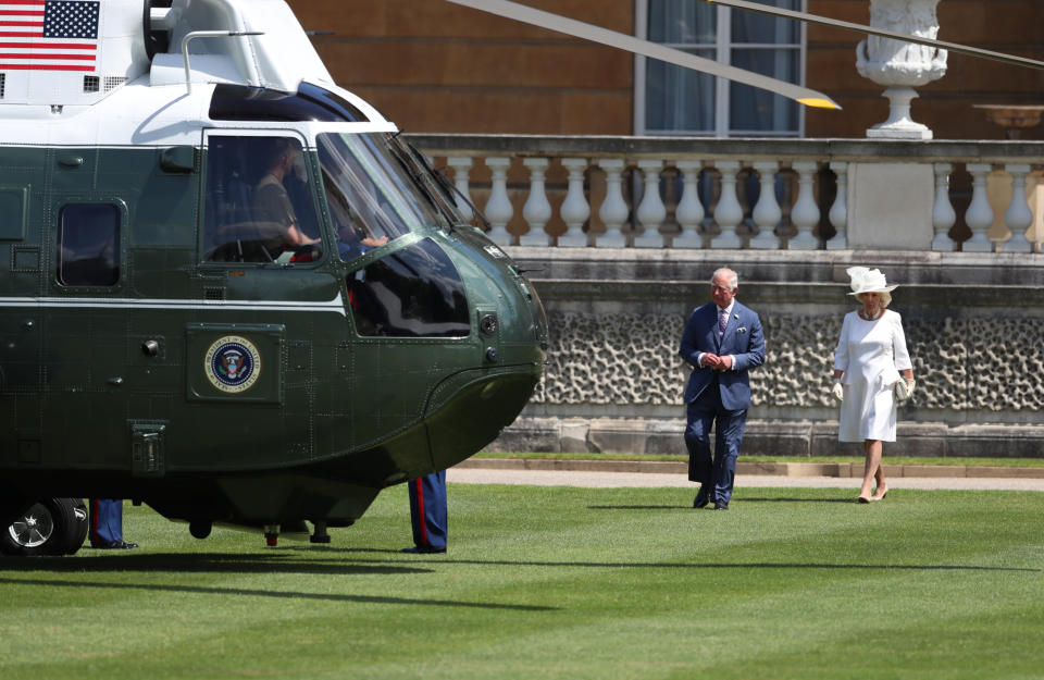 The Prince of Wales and the Duchess of Cornwall wait to meet US President Donald Trump and his wife Melania as they arrive in Marine One at Buckingham Palace, in London on day one of his three day state visit to the UK.